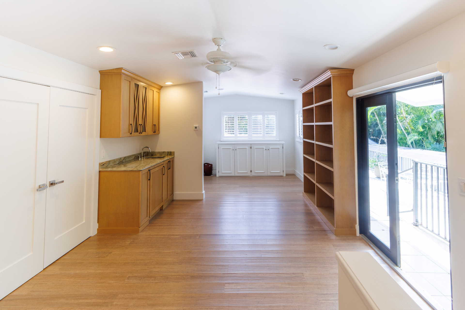 Upstairs loft with wet bar, built-in shelving and balcony access