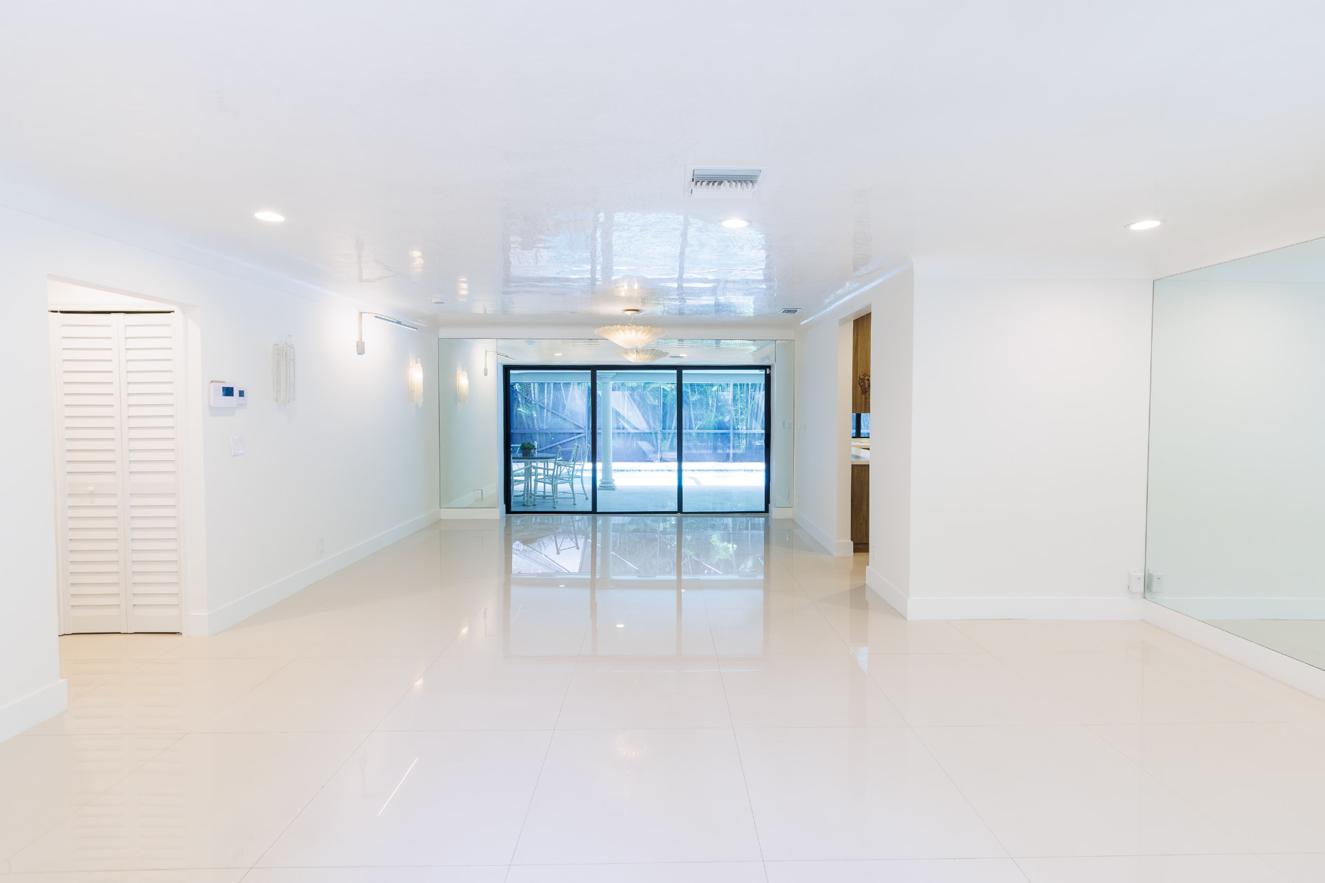 Great room with polished tile floors opening to the pool through sliding glass doors
