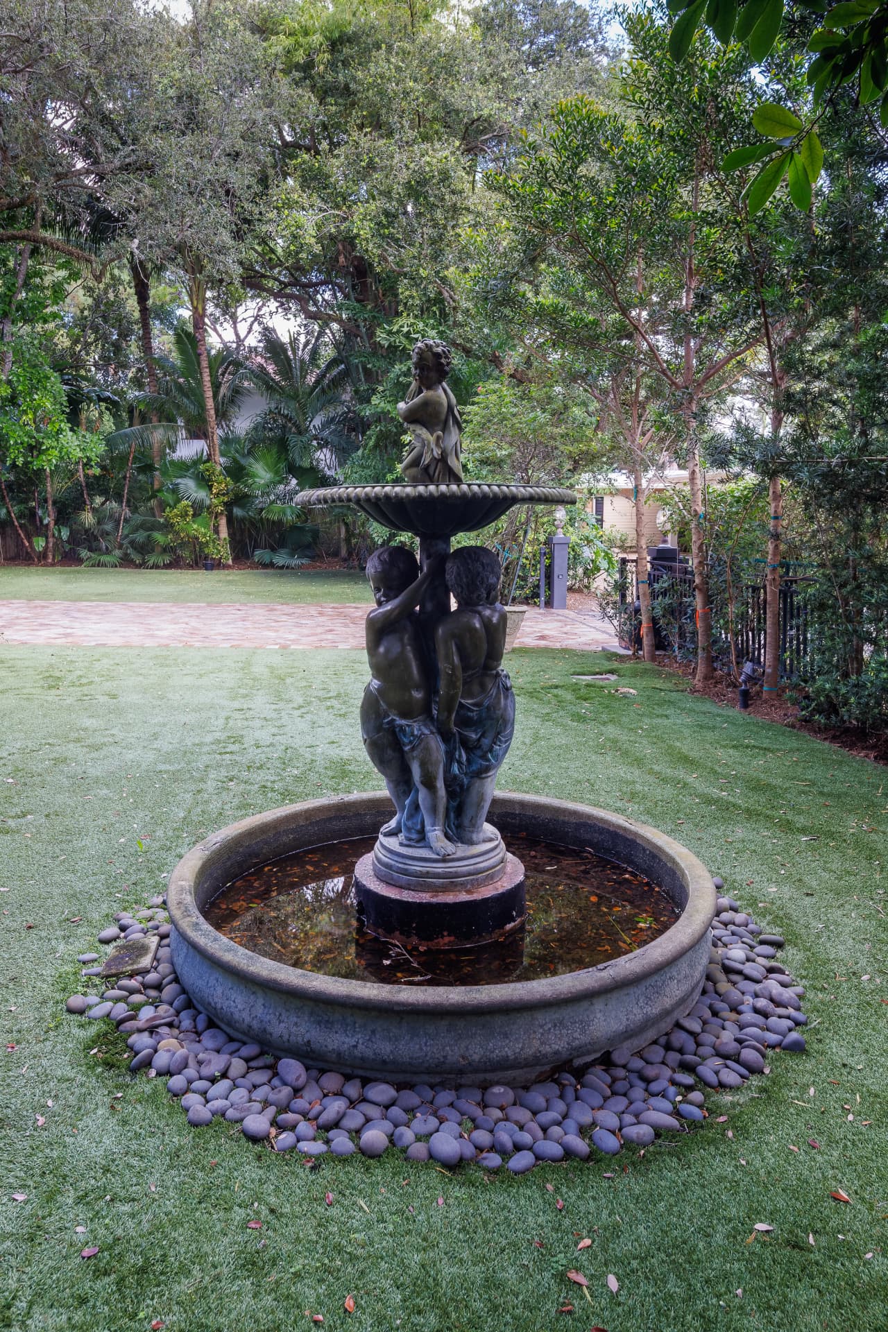 Classical stone fountain among river stones