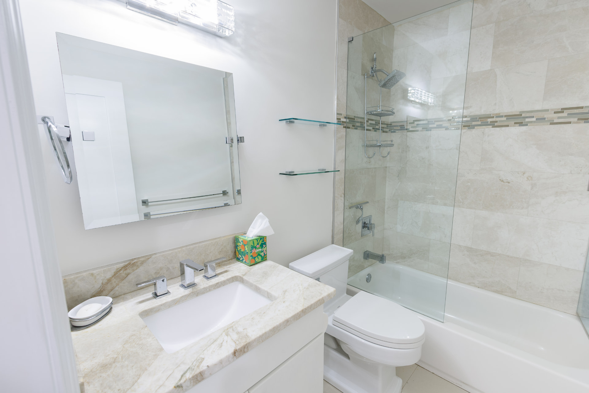 Bath with marble-look vanity, shower-tub and glass shelving
