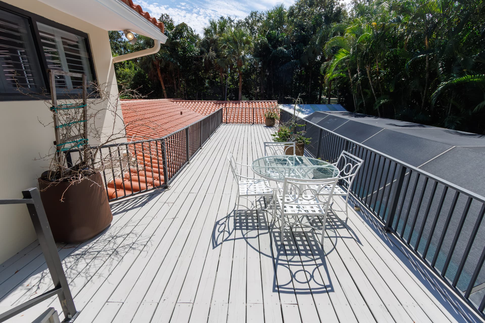 Rooftop terrace overlooking the tile roof and tropical canopy