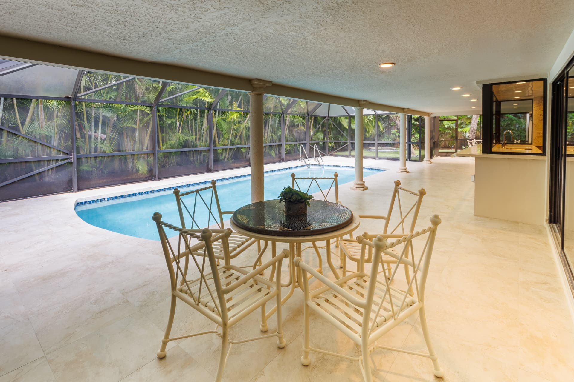 Poolside dining table beside the water