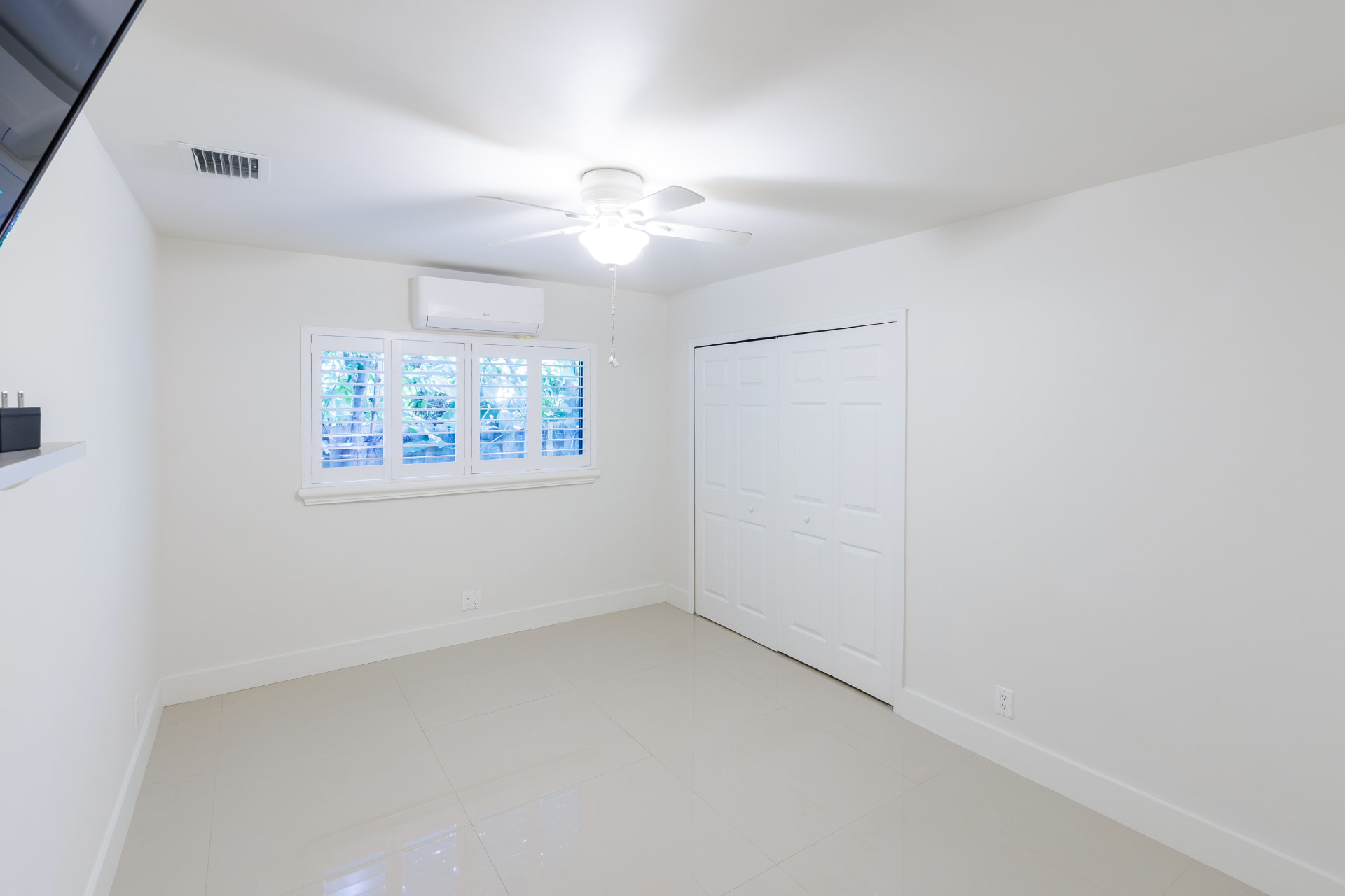 Bedroom with double closets and polished tile floors