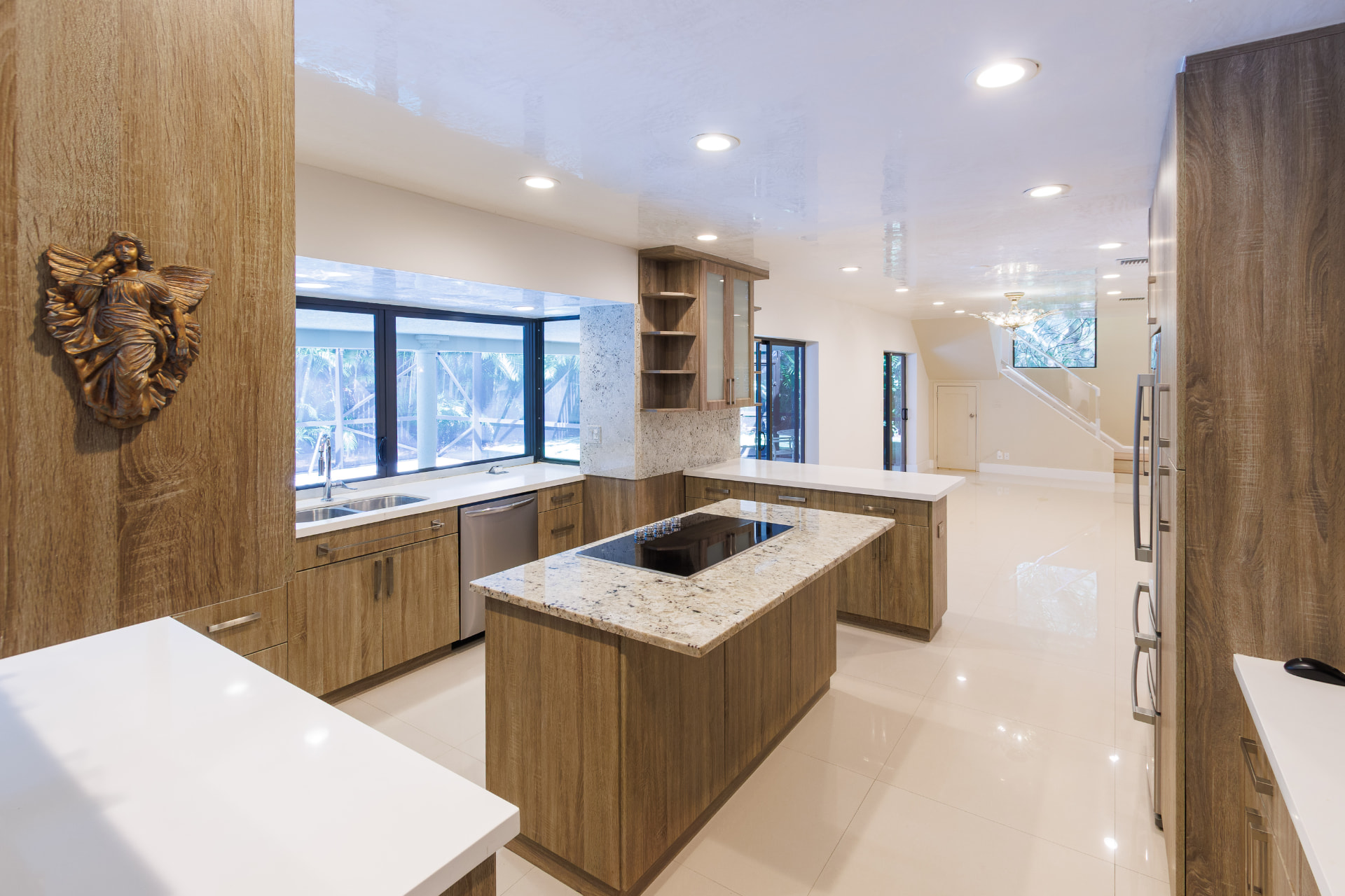 Kitchen opening toward the family room and staircase