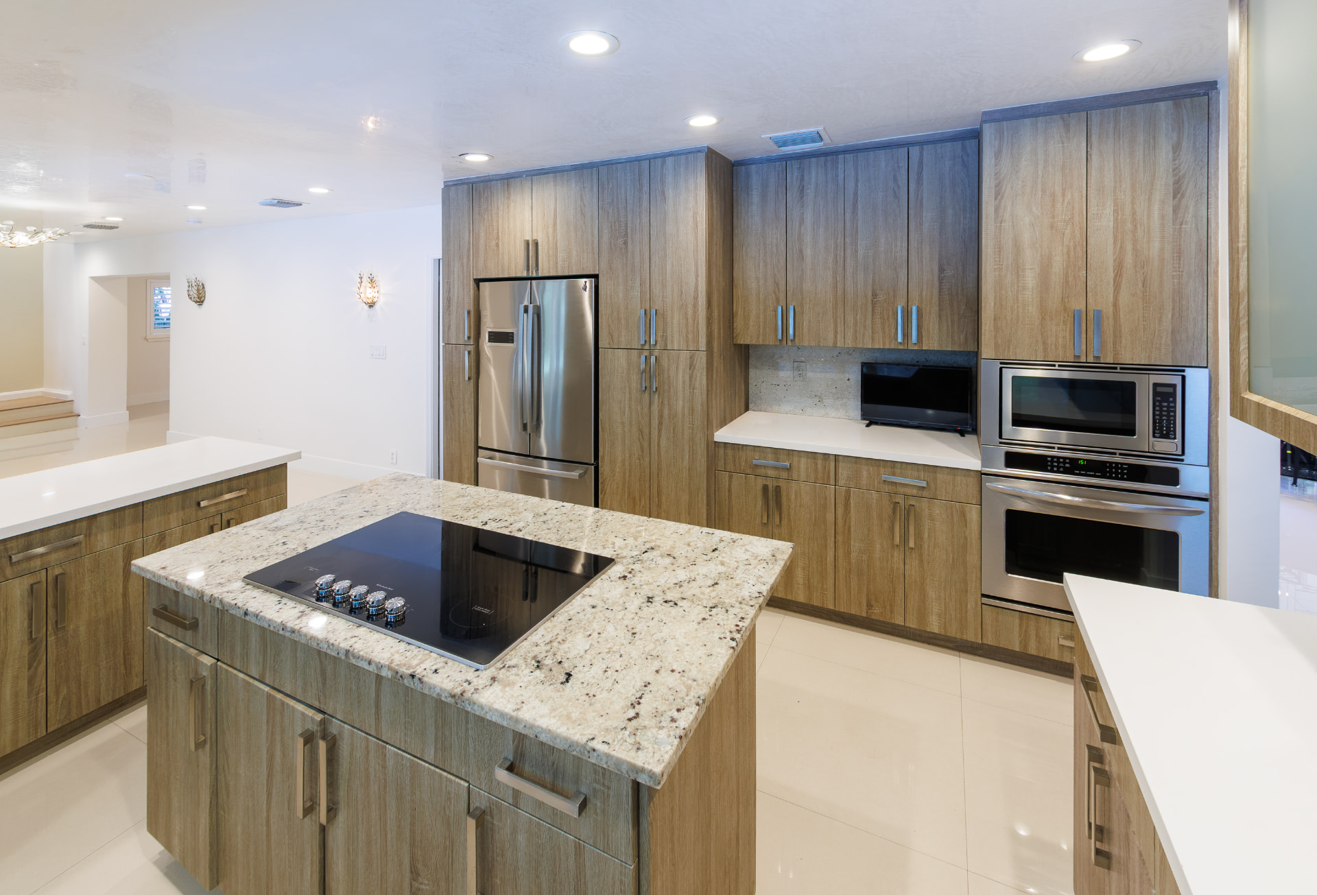 Kitchen island with induction cooktop and built-in wall ovens