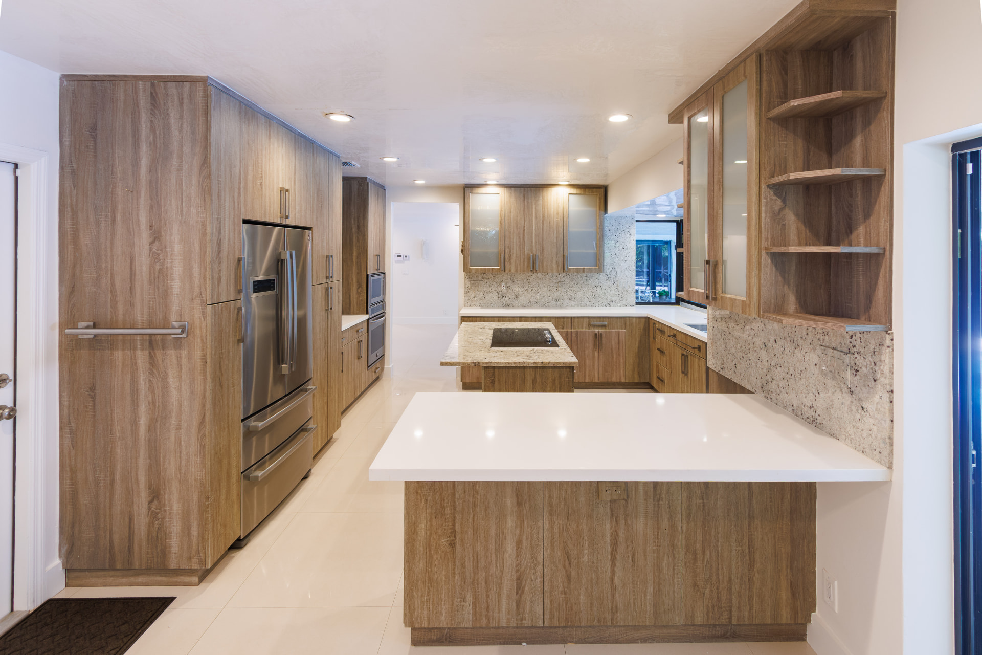 Chef's kitchen with custom wood cabinetry and stainless appliances